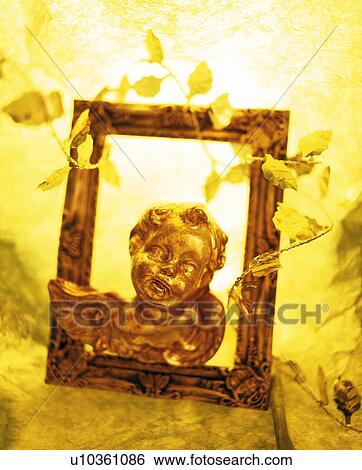 Stock Photograph - Cherub figurine in picture frame. Fotosearch