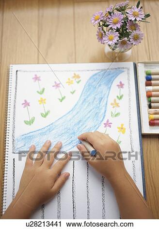 Stock Image - Child drawing on paper. Fotosearch