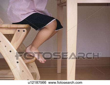 Child sitting on a chair View Large Photo Image Stock Photograph - Child sitting on a chair. Fotosearch