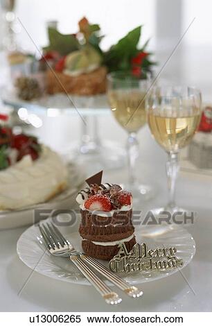 Stock Photography - Chocolate Christmas cake with champagne glasses. Fotosearch