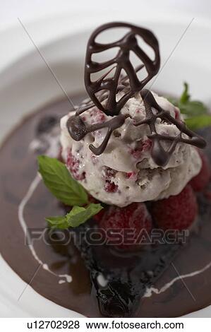 Stock Photo - Chocolate crepes with ice cream and berries. Fotosearch