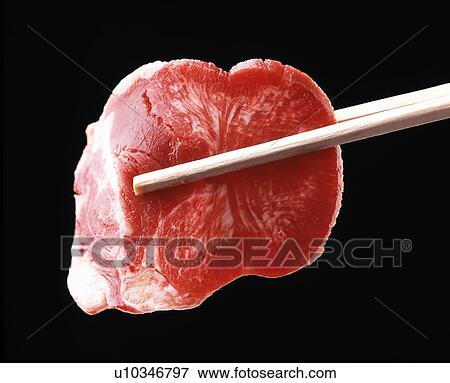 Chopsticks holding raw meat View Large Photo Image Stock Photo - Chopsticks holding raw meat. Fotosearch
