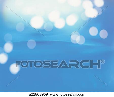 Stock Photo - Circles of light on blue background. Fotosearch