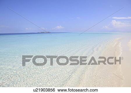 Stock Photograph - Clear water and white sand beach, Maldive Islands. Fotosearch