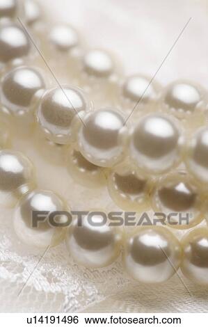 Close up of white pearls and lace View Large Photo Image Stock Photograph - Close up of white pearls and lace. Fotosearch