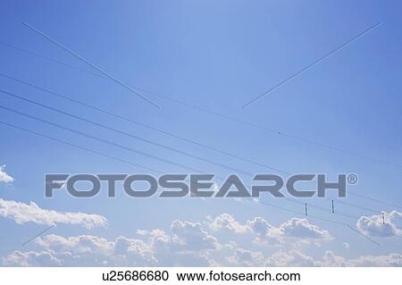 Clouds and power lines in blue sky, blue background, copy space View Large Photo Image Stock Image - Clouds and power lines in blue sky, blue background, copy space. Fotosearch