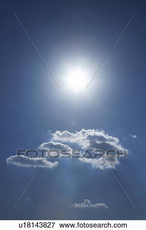 Stock Photo - Clouds and sun in blue sky, Tokyo prefecture, Japan. Fotosearch
