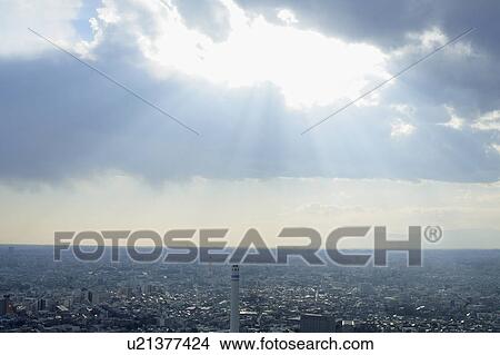 Picture - Clouds and sunbeams over office buildings, Tokyo prefecture, Japan. Fotosearch