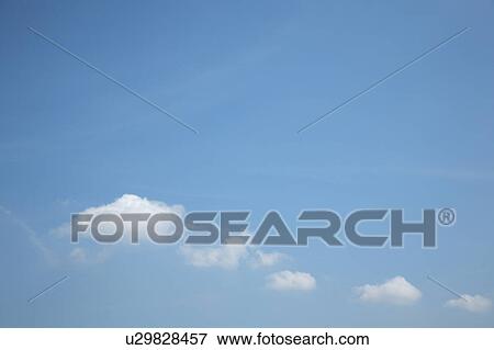 Stock Photo - Clouds in blue sky, blue background, copy space, Tokyo prefecture, Japan. Fotosearch