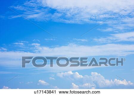 Stock Image - Clouds in blue sky. Fotosearch