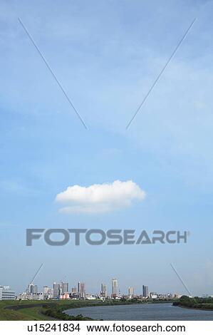 Picture - Clouds over office buildings, copy space, Tokyo prefecture, Japan. Fotosearch