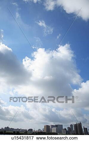 Stock Photo - Clouds over office buildings, Tokyo prefecture, Japan. Fotosearch