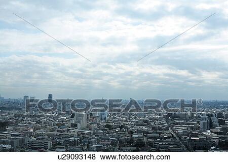 Stock Photo - Clouds over office buildings, Tokyo prefecture, Japan. Fotosearch