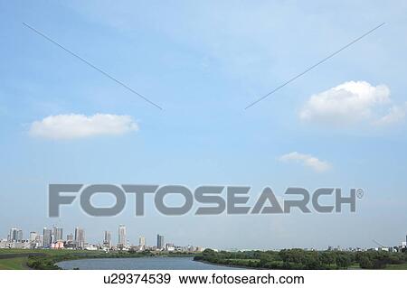 Stock Photo - Clouds over office buildings, Tokyo prefecture, Japan. Fotosearch