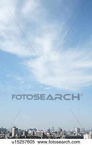 Stock Photography - Clouds over office buildings, Tokyo prefecture, Japan. Fotosearch
