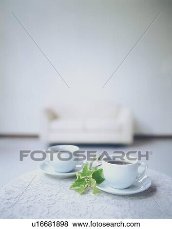 Stock Photo - Coffee and plant on a living room coffee table. Fotosearch