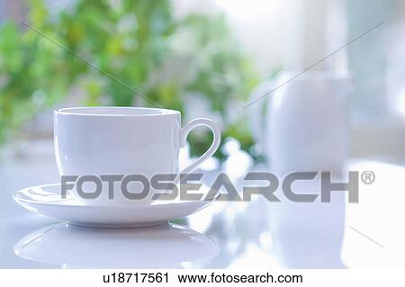 Stock Image - Coffee cup on table. Fotosearch
