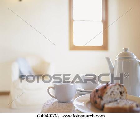Stock Photo - Coffee cups and coffee pot on a breakfast table. Fotosearch