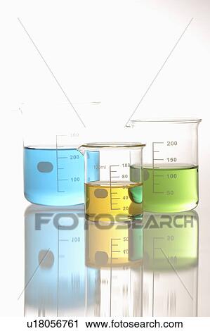 Stock Image - Colorful liquids in beaker, white background. Fotosearch