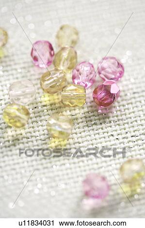 Coloured beads on shiny white textile View Large Photo Image Stock Image - Coloured beads on shiny white textile. Fotosearch