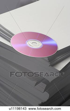 Compact disc on piled papers, close up View Large Photo Image Stock Image - Compact disc on piled papers, close up. Fotosearch