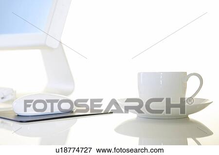 Stock Photo - Computer and cup, white background. Fotosearch