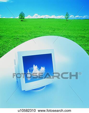 Stock Image - Computer in a field - digital composite. Fotosearch