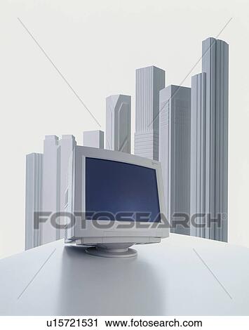 Stock Image - Computer in front of model buildings - digital composite. Fotosearch
