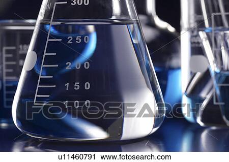 Stock Image - Conical flask with liquid, close up. Fotosearch