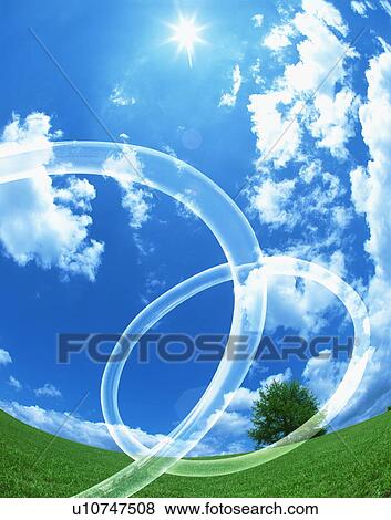 Connected rings in a field under a blue sky View Large Photo Image Stock Photo - Connected rings in a field under a blue sky. Fotosearch