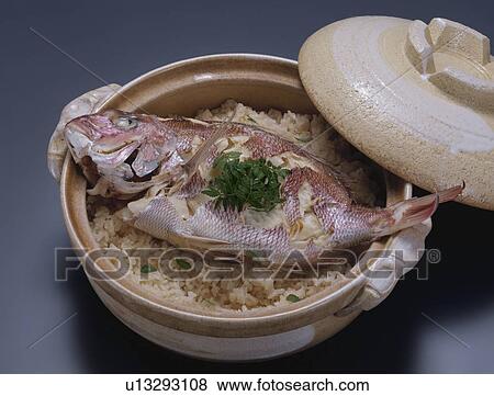 Cooked sea bream on rice in crock pot, black background View Large Photo Image Stock Photo - Cooked sea bream on rice in crock pot, black background. Fotosearch