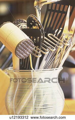 Stock Image - Cooking utensils in a wire basket. Fotosearch