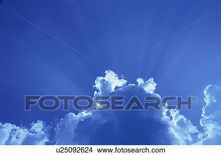 Crepuscular rays from behind clouds View Large Photo Image Picture - Crepuscular rays from behind clouds. Fotosearch