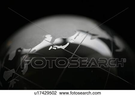 Stock Image - Crystal globe on black background. Fotosearch