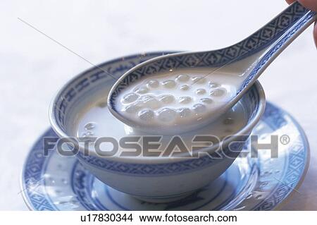 Picture - Cup of coconut milk and tapioca, close up. Fotosearch