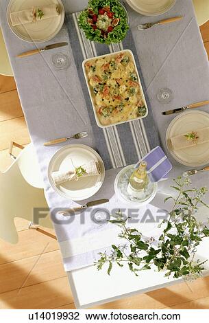 Dining table for four with gratin dish View Large Photo Image Stock Image - Dining table for four with gratin dish. Fotosearch