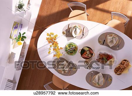Stock Image - Dining table set for four. Fotosearch