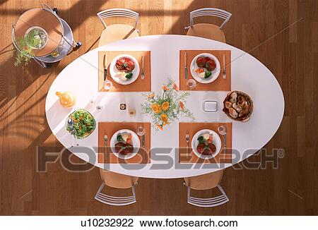 Stock Image - Dining table with four meals. Fotosearch