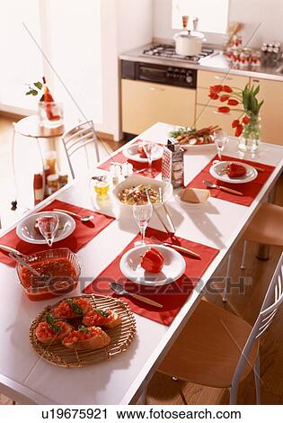 Stock Image - Dining table with meal for four. Fotosearch