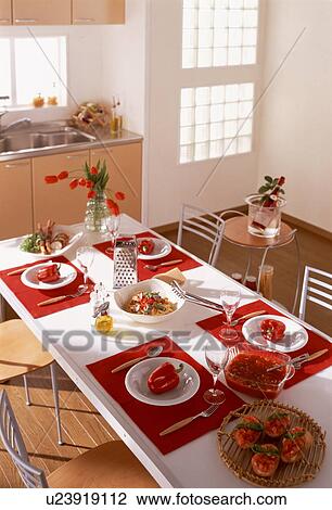 Stock Image - Dining table with meal for four. Fotosearch