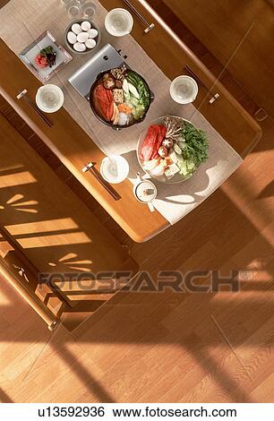 Stock Photograph - Dining table with steamboat dishes. Fotosearch