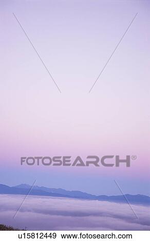 Stock Photo - Distant view of Minami-Alps at dawn. Nagano Prefecture, Japan. Fotosearch