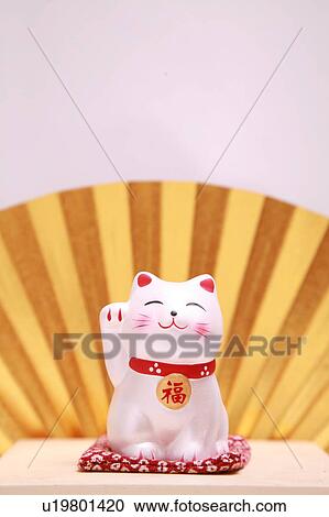 Doll of cat with a beckoning paw, white background View Large Photo Image Stock Image - Doll of cat with a beckoning paw, white background. Fotosearch