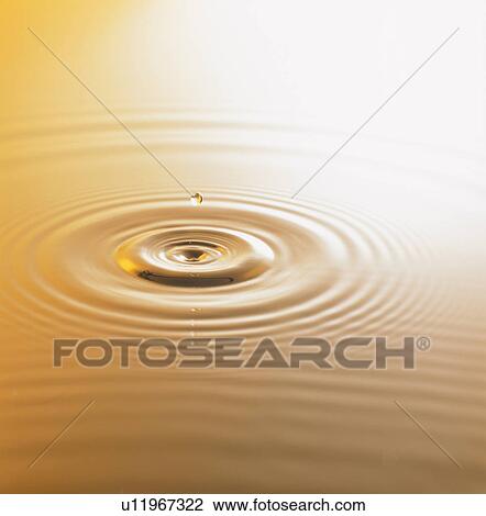 Stock Image - Drop of water falling and splashing. Fotosearch