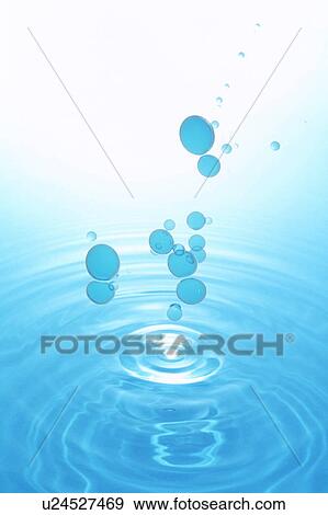 Drops creating concentric circles on water surface View Large Photo Image Stock Photo - Drops creating concentric circles on water surface. Fotosearch