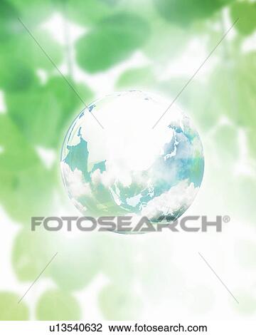 Stock Image - Earth floating among green leaves. Fotosearch