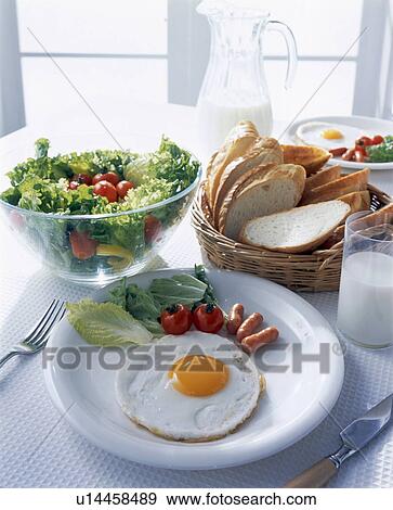 Egg and sausage meal with salad and bread View Large Photo Image Stock Photo - Egg and sausage meal with salad and bread. Fotosearch