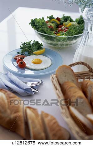 Stock Photography - Egg meal with salad and bread. Fotosearch