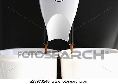 Espresso machine pouring coffee into cups, close up, black background View Large Photo Image Stock Photo - Espresso machine pouring coffee into cups, close up, black background. Fotosearch