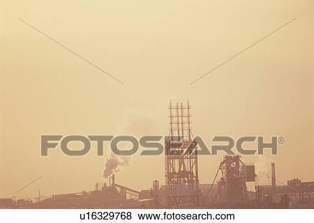 Stock Photo - Factory emitting smoke into orange sky. Shinonome, Koto-ku, Tokyo. Fotosearch
